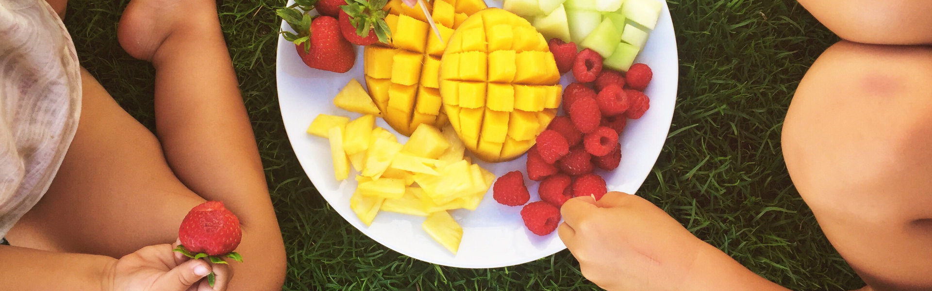 Children eating fruit.